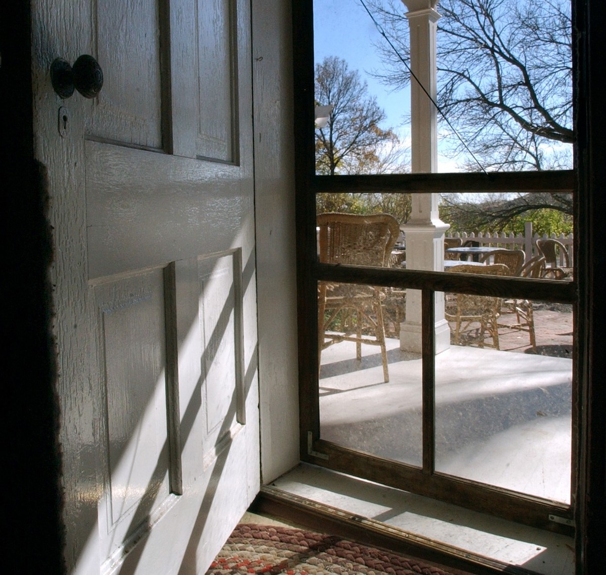 screened-front-door A front door is open to a screen door.