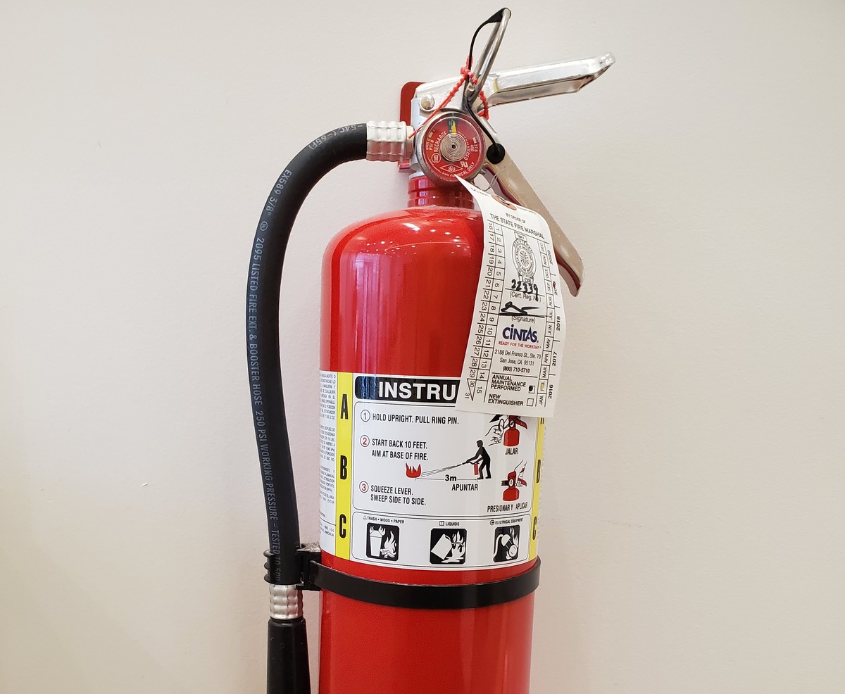 mounted-fire-extinguisher A fire extinguisher is mounted to a wall.