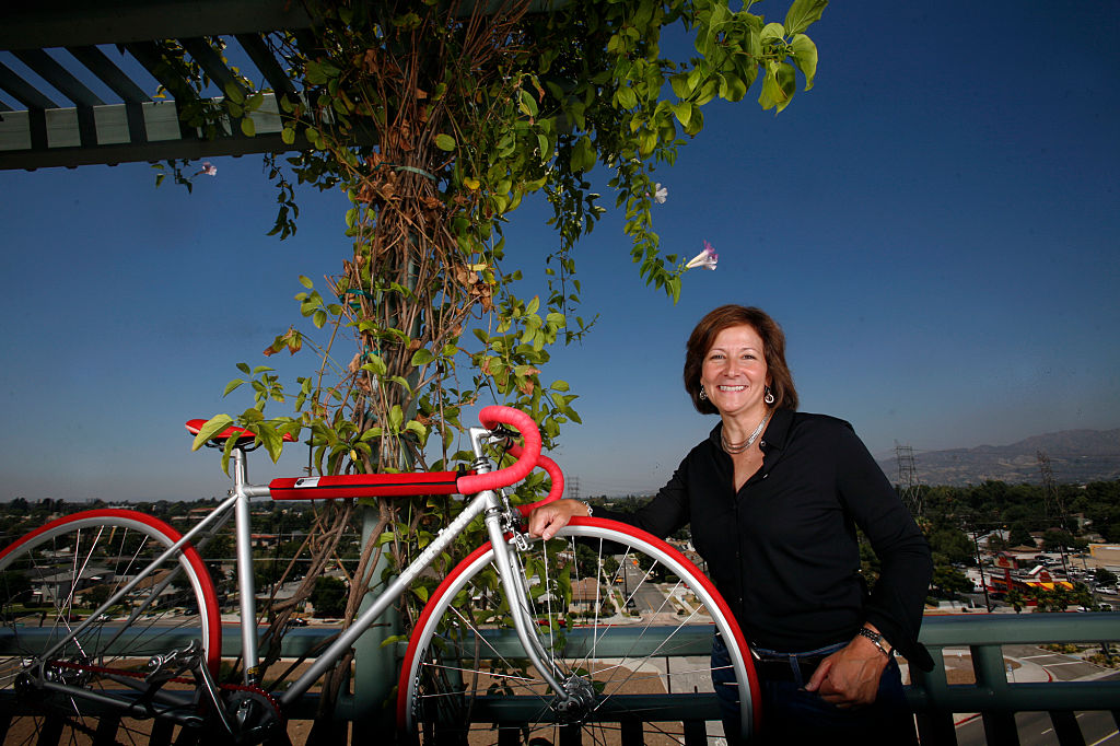 bike-on-balcony A woman poses with her bike on a balcony.