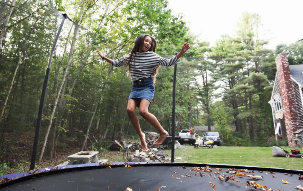 jumping-on-a-trampoline A girl jumps on a trampoline.