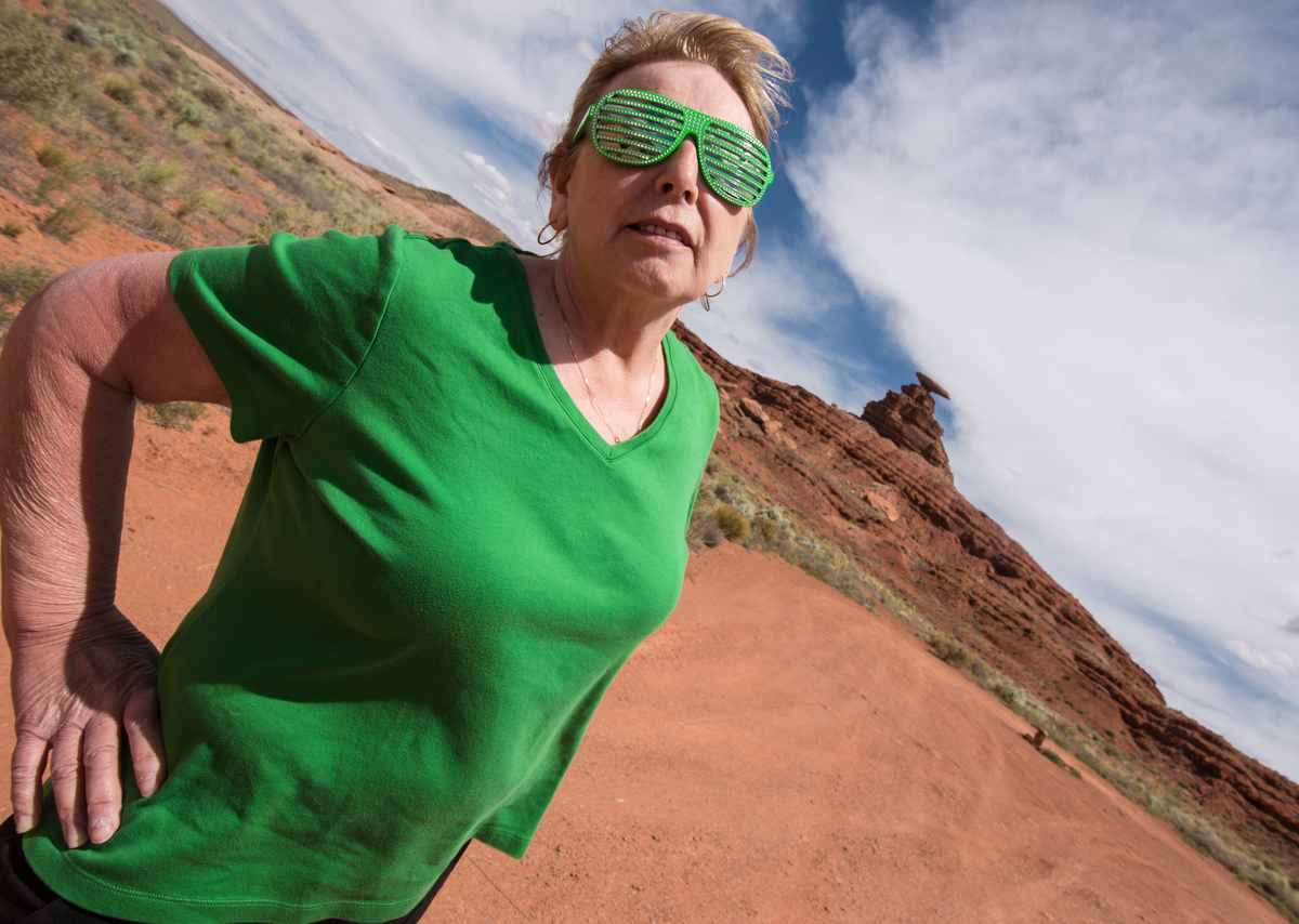 shutter shades A woman on a hike wears green shutter shades.