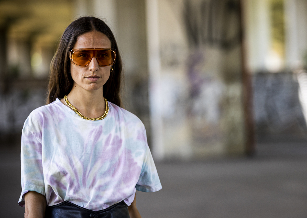 tie dye shirt-1156651405 A woman wears a tie dye t-shirt.