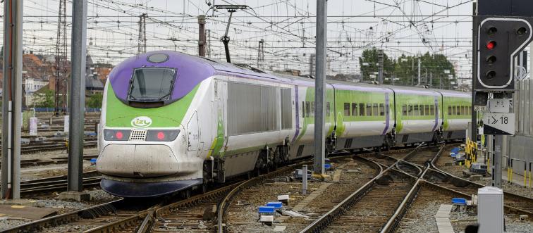 A high-speed train leaves a station in Brussels.