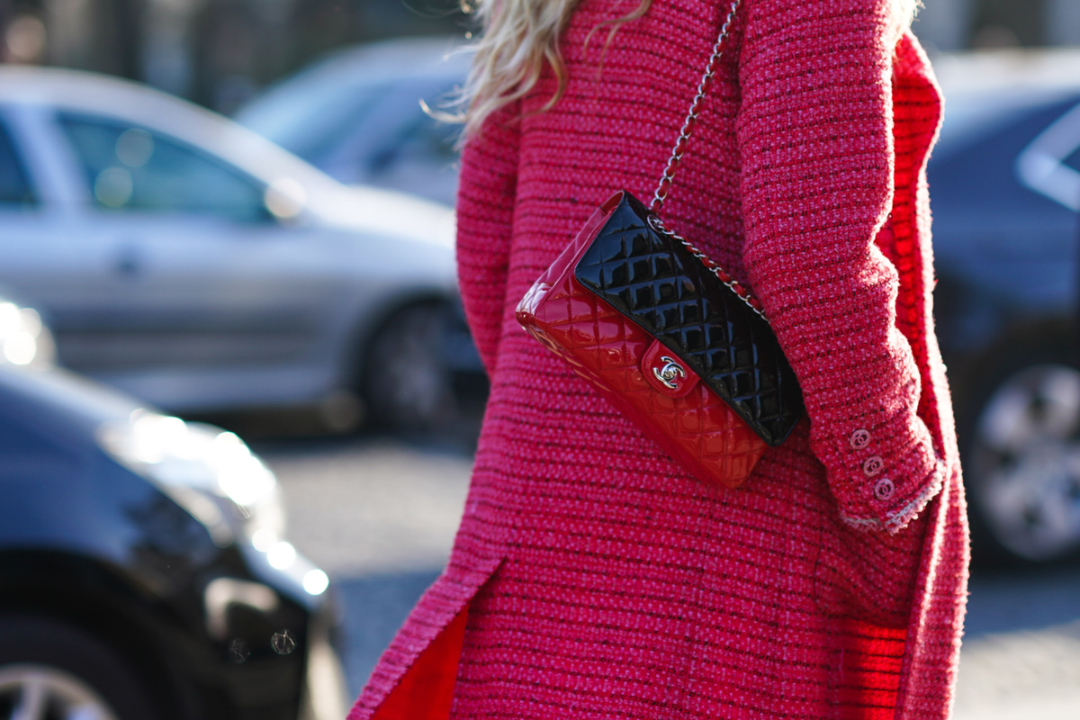 tweed jacket - 1201935332 A woman walks through the streets of Paris in a pink tweed coat.