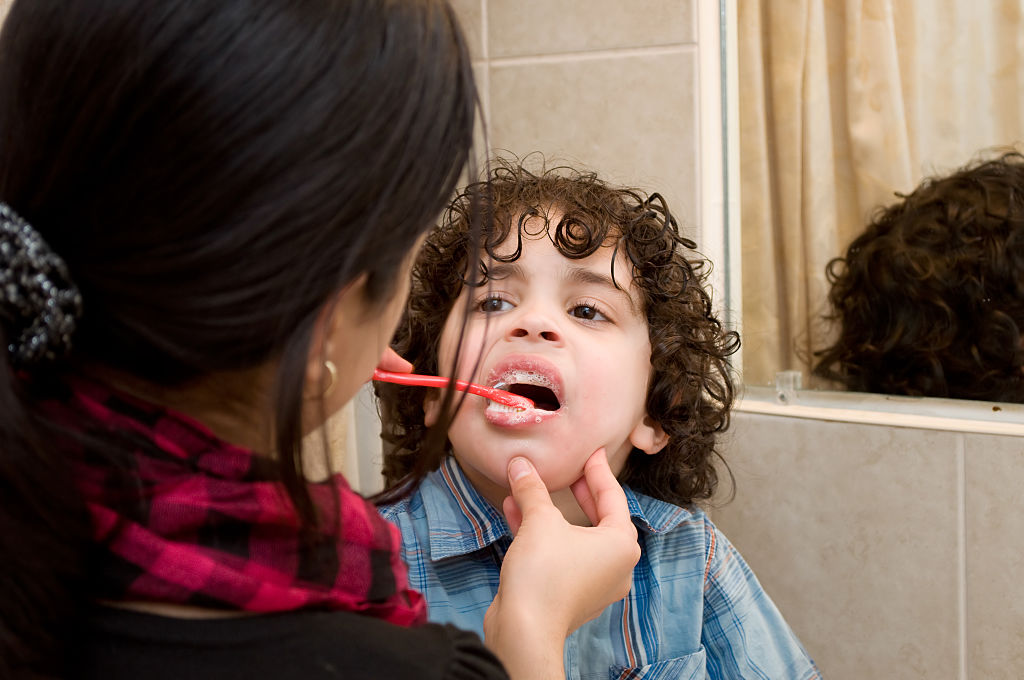 toothpaste-475700972 kid getting his teeth cleaned