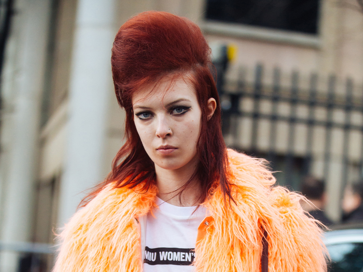 poofy hair - 952546252 A model in Paris has red puffed and teased hair.