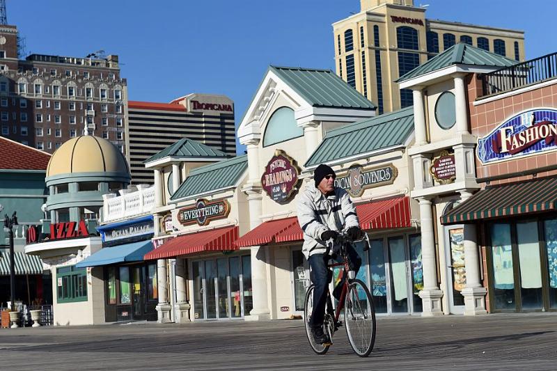 a cyclist riding along the atlantic city boardwalk