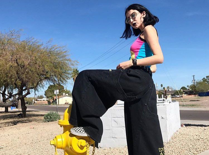 baggy jeans A woman wears black baggy JNCO jeans and steps on a fire hydrant.