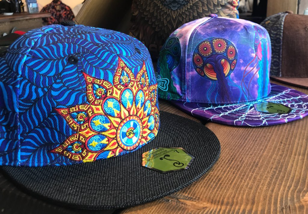 colorful trucker hats Two trucker hats have colorful designs on them.