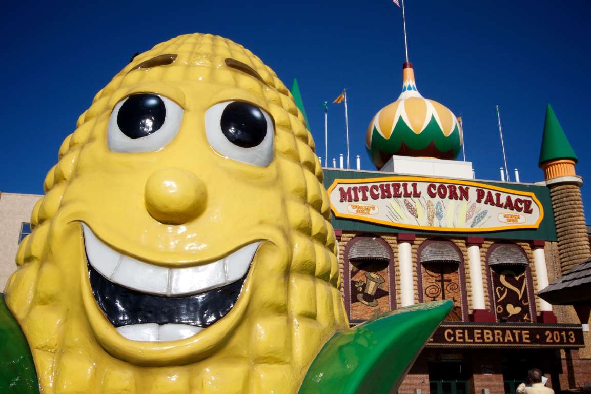 a statue of corn in front of the corn palace