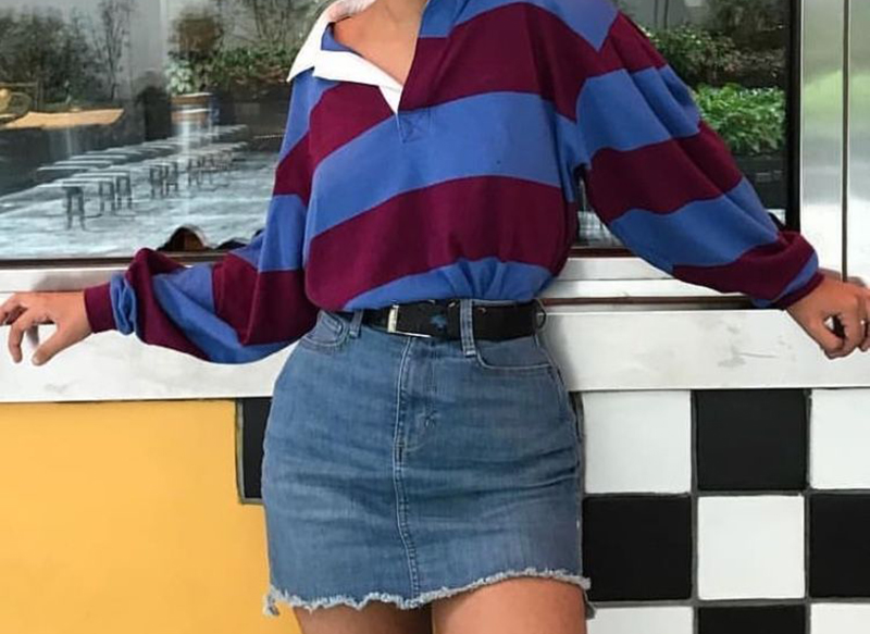 polo shirt skirt A woman wears an over-sized polo shirt and denim skirt.