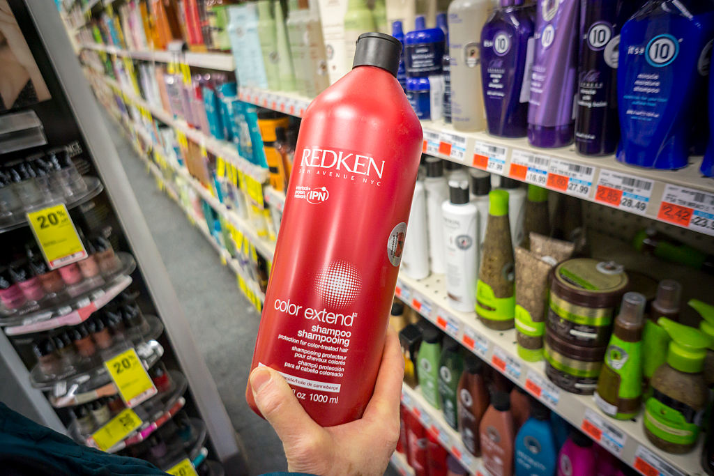 shampoo A shopper holds a bottle of Redken brand shampoov