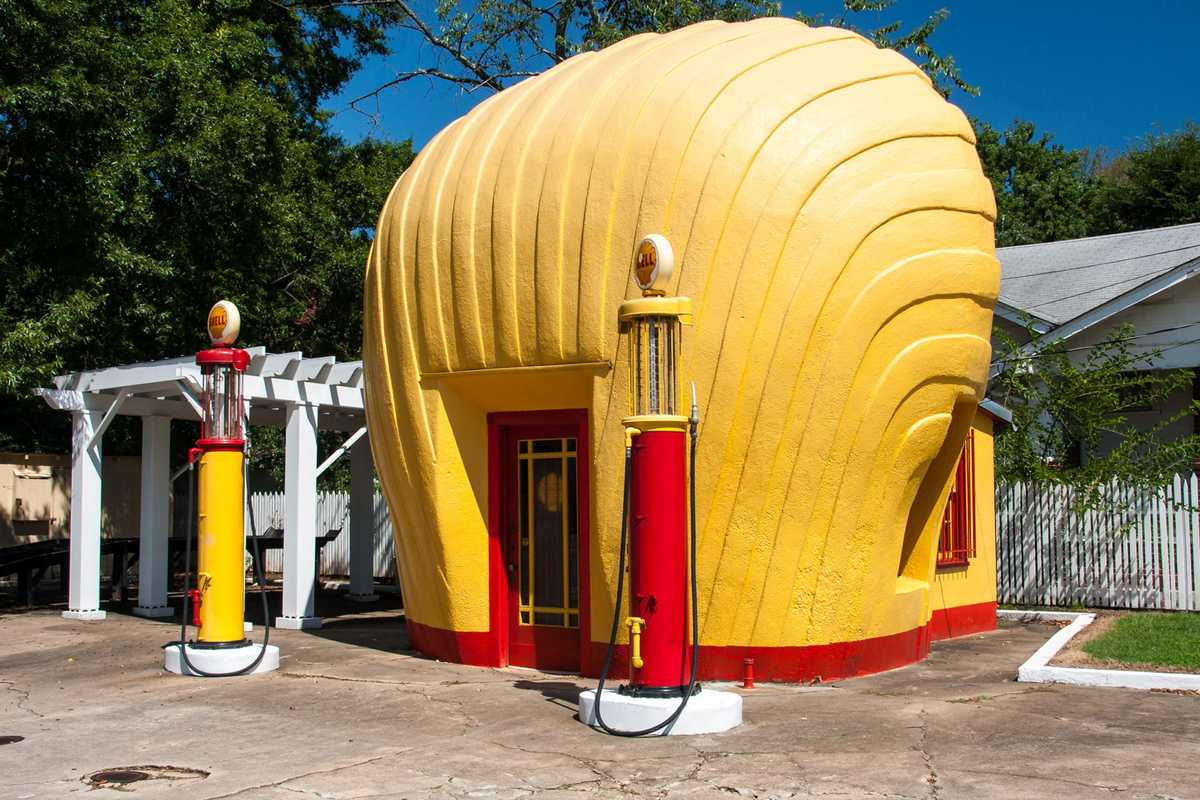 a gas station in the shape of a yellow shell
