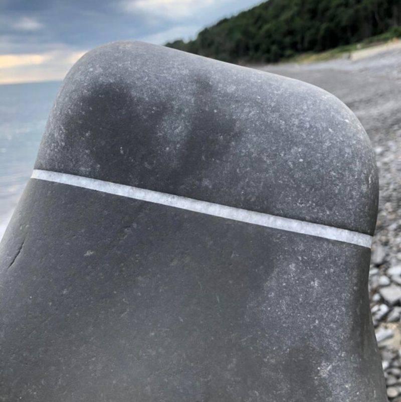 a rock with a perfect line etched in 