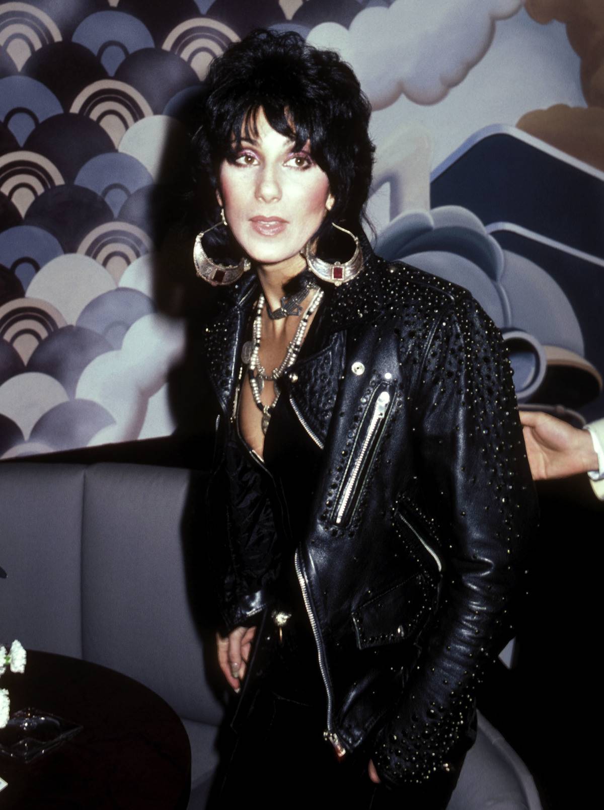 Cher is dressed in a stunned leather jacket with Joan Jett-style hair.