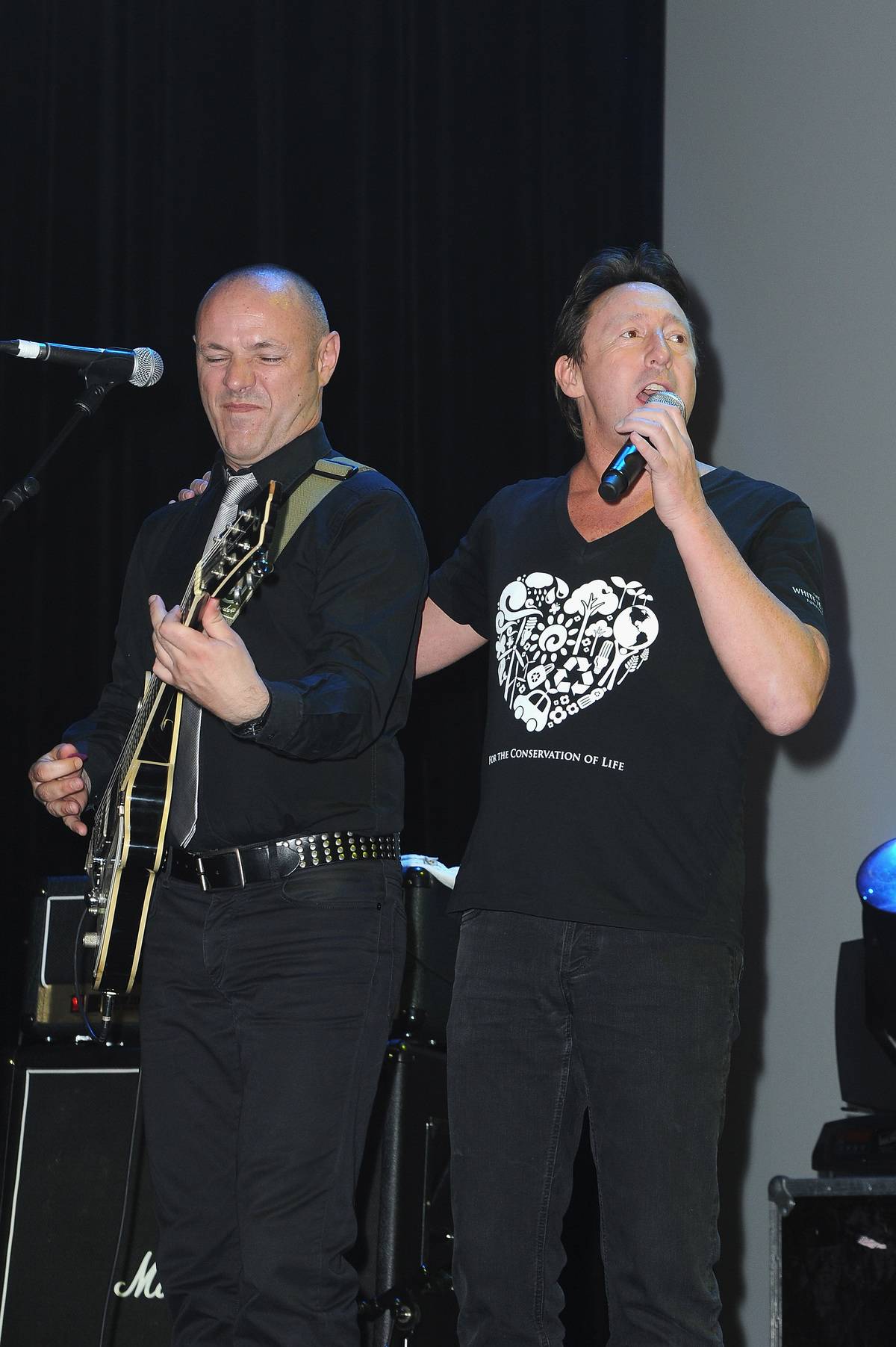 Julian sings at an event for his White Feather Foundation.