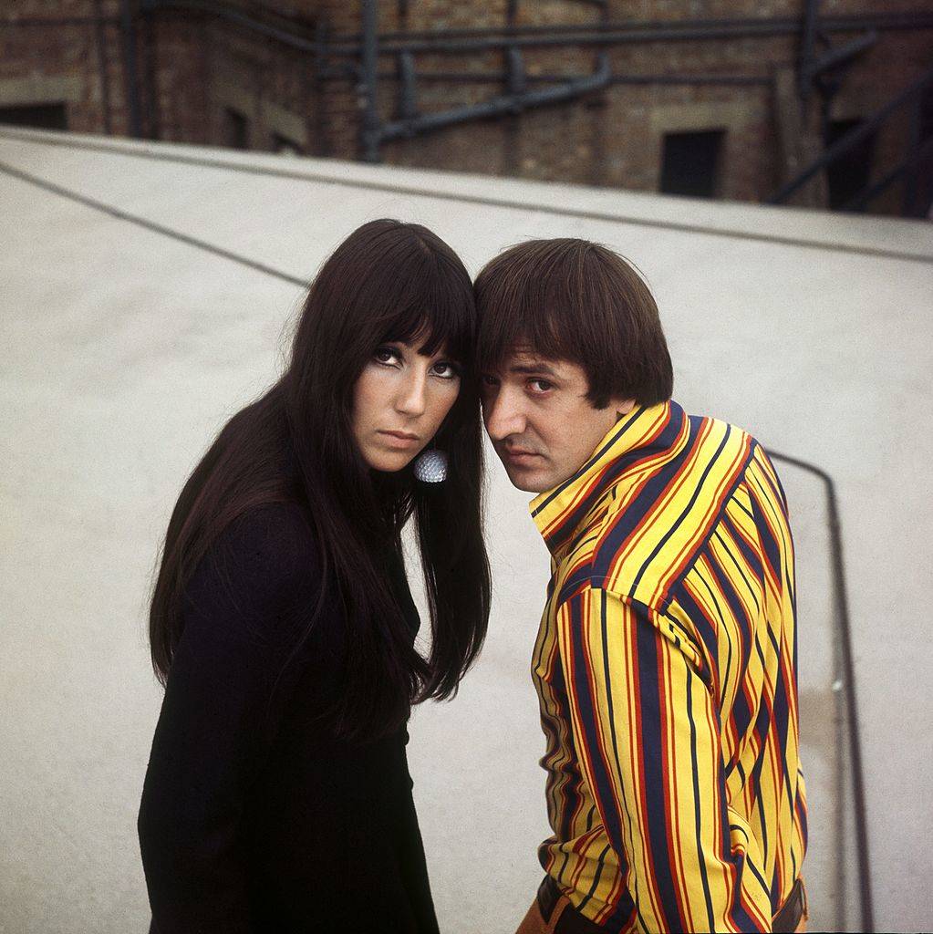 Sonny and Cher pose with their heads together in London.