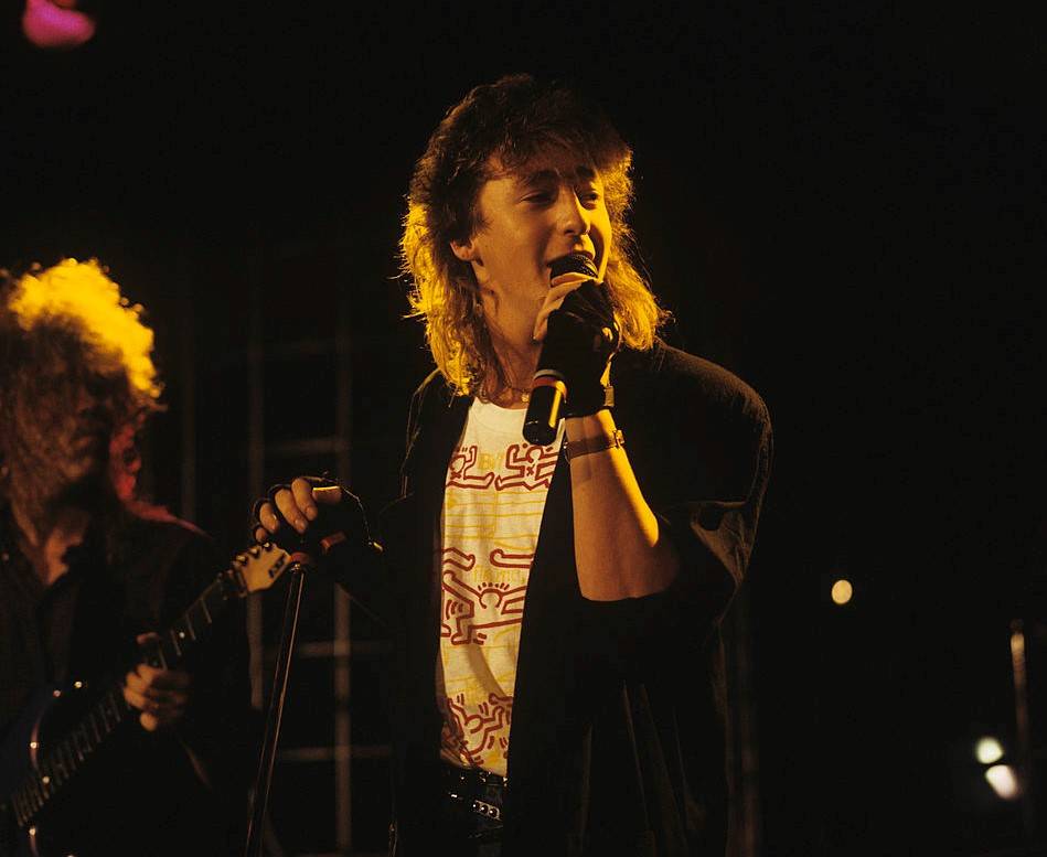 Julian sings onstage.