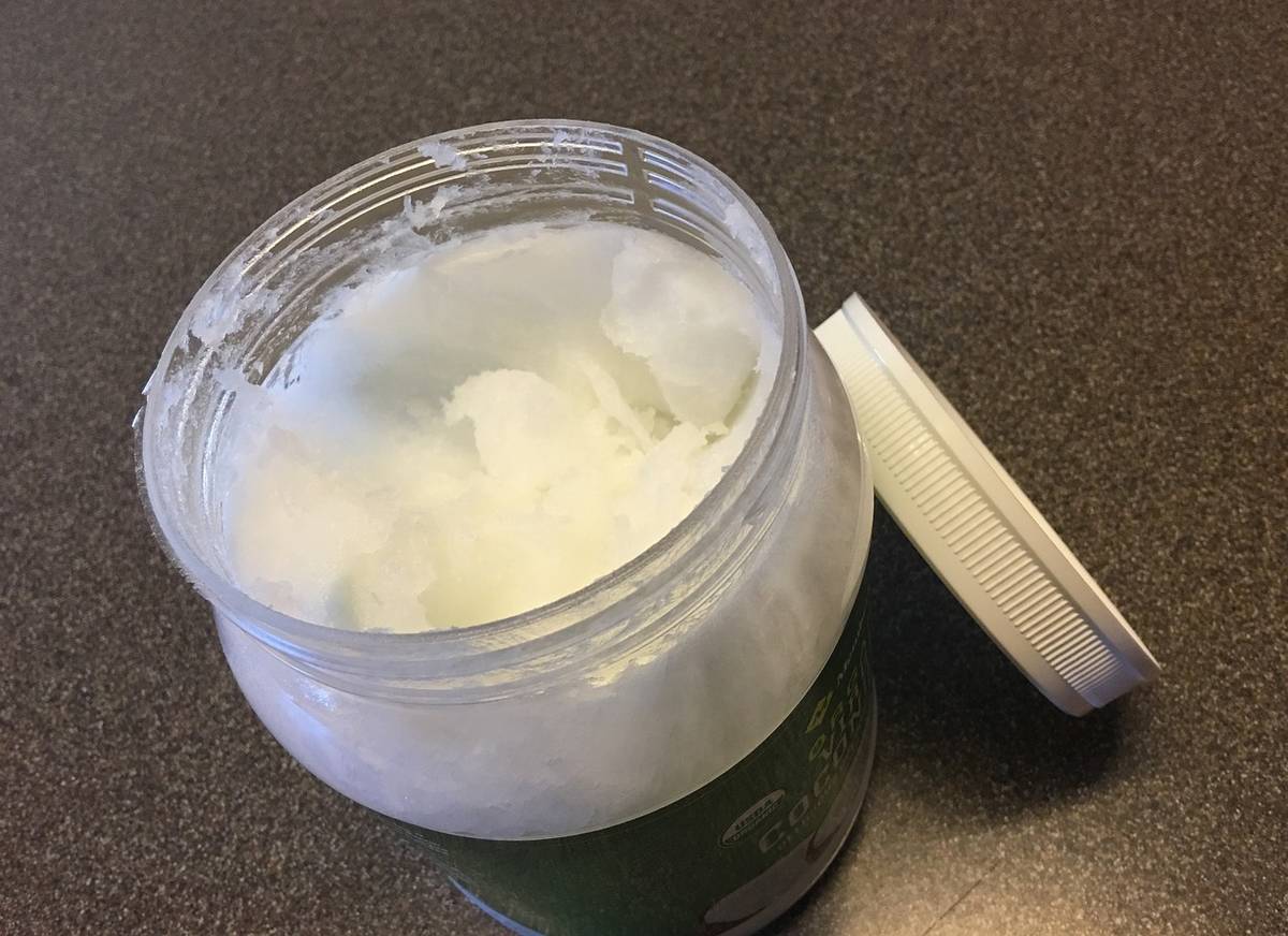 A container holds coconut oil.
