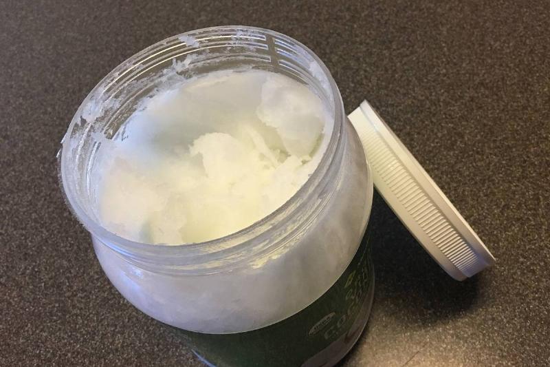 coconut oil A container holds coconut oil.
