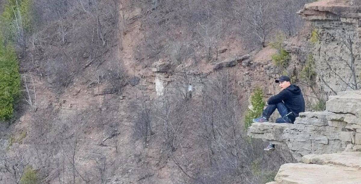 A woman appears to be standing on the hillside.