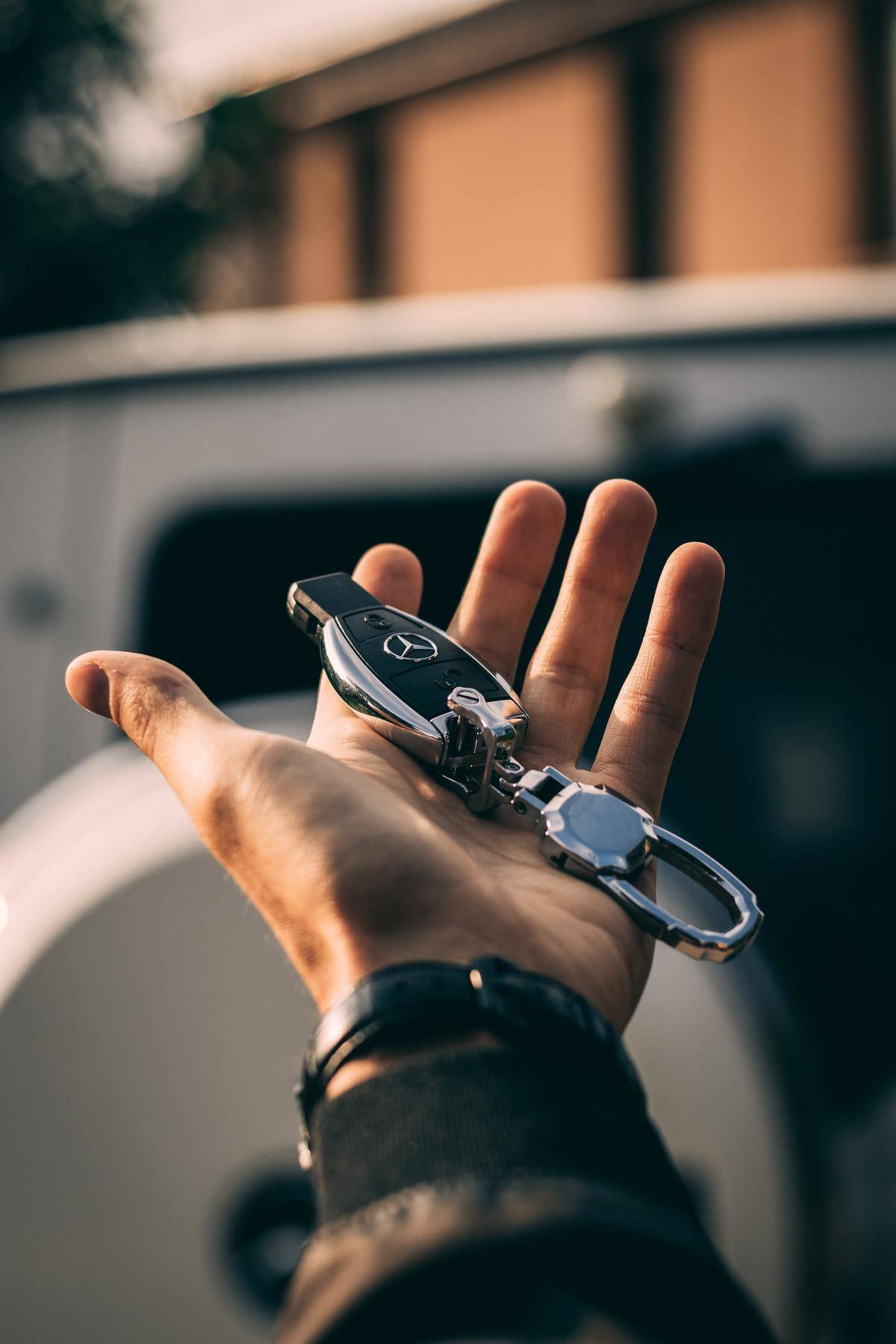 A person holds car keys in their hand.