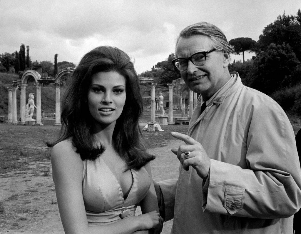 British director Ken Annakin giving directions to American actress Raquel Welch