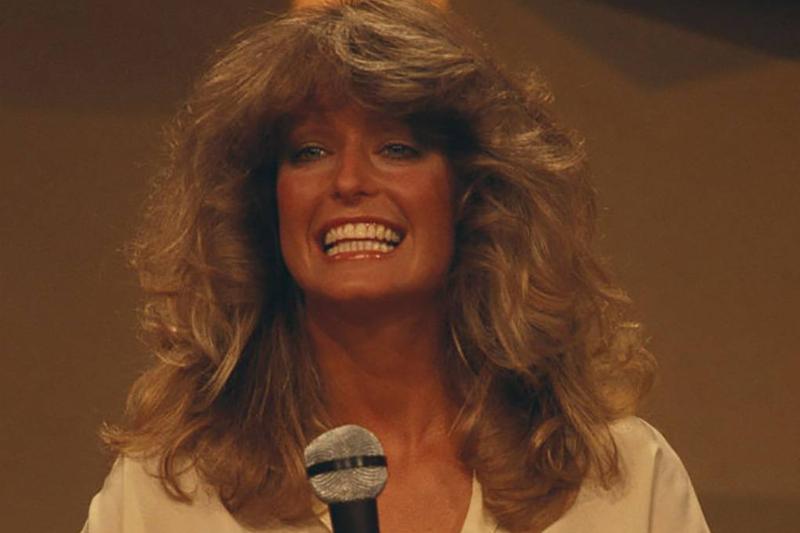 Fawcett with a microphone 