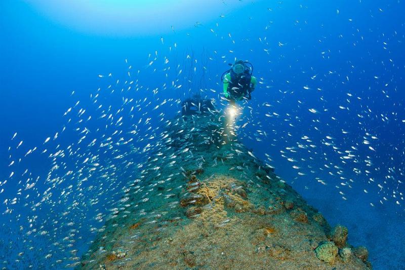 Man underwater with submarine