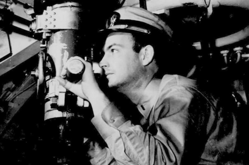 Man looking through periscope 