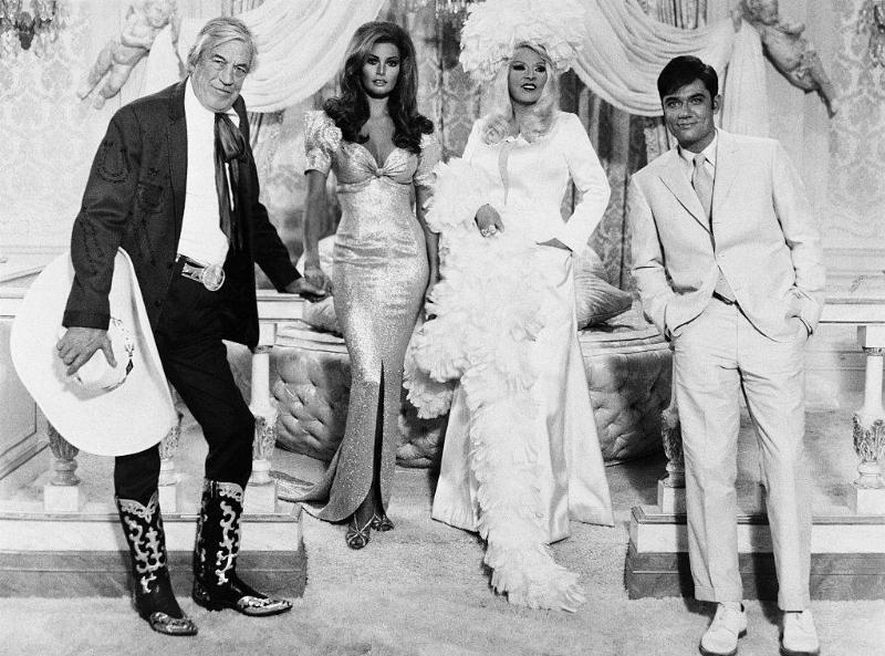 Left to right: John Huston as Buck Loner, Raquel Welch as Myra Breckinridge, Mae West as Leticia Van Allen, and Rex Reed as Myron.