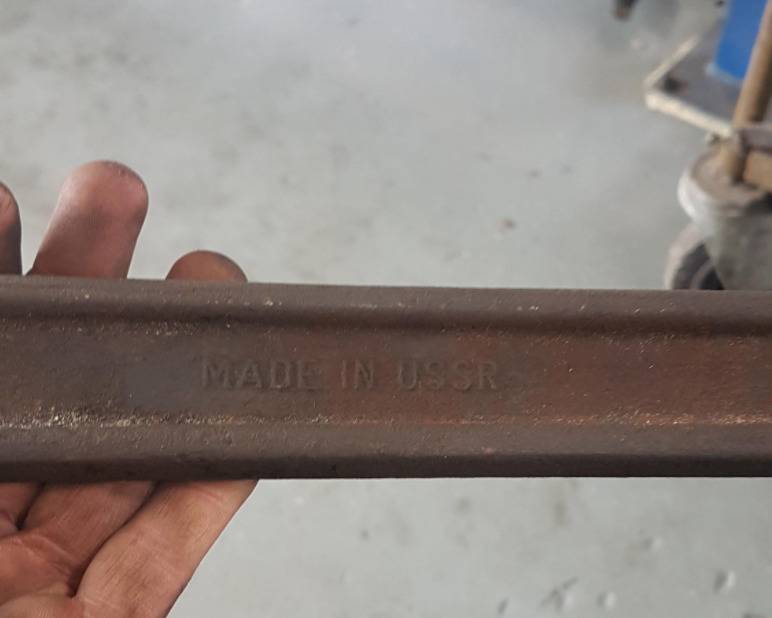man holds tool that says 