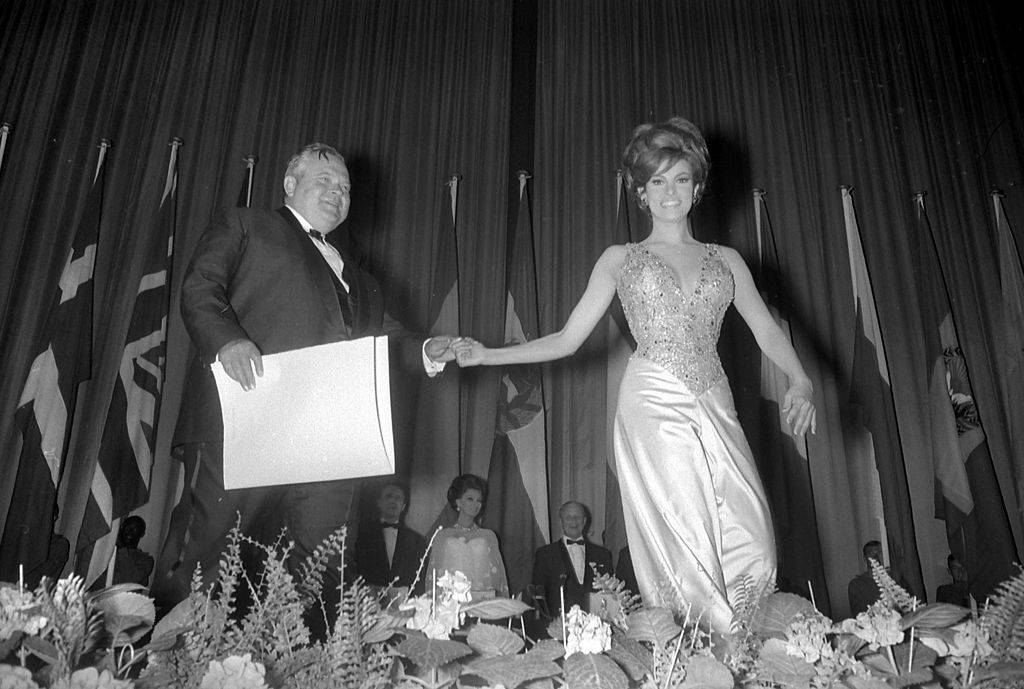 Raquel Welch handing an award to Orson Welles