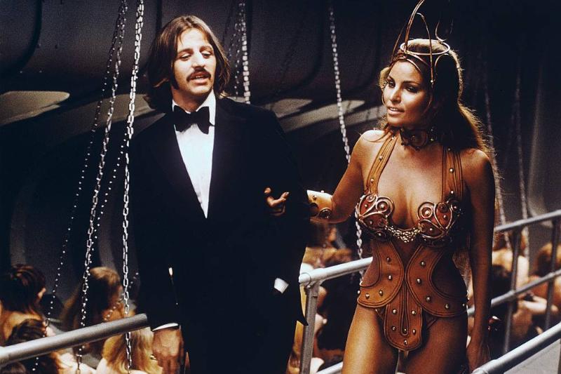 Beautiful Raquel Welch is a special guest as a slave priestess in charge of a bevy of topless girl rowers aboard a luxury liner in Commonwealth United's The Magic Christian. She is pictured with Ringo Starr who co-stars in the comedy film with Peter Sellers.
