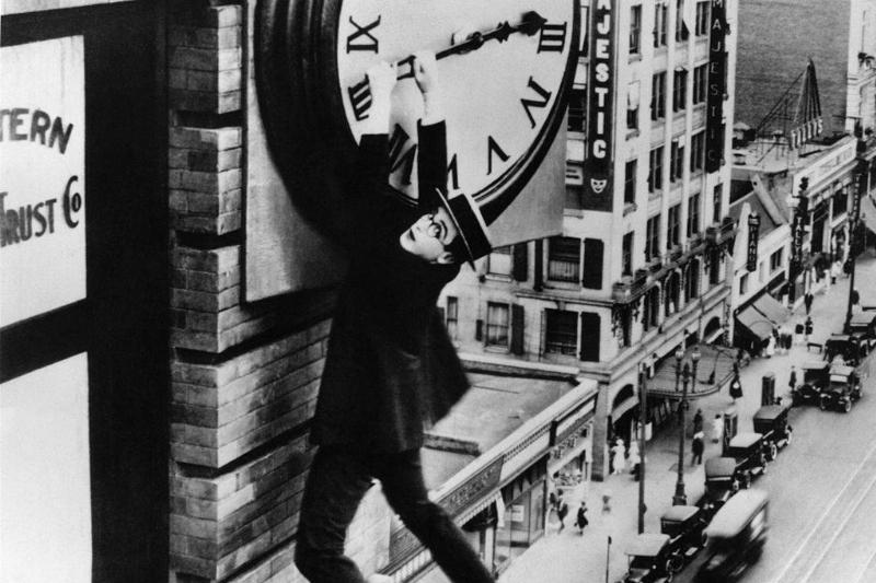 Llyod hanging from a clock 