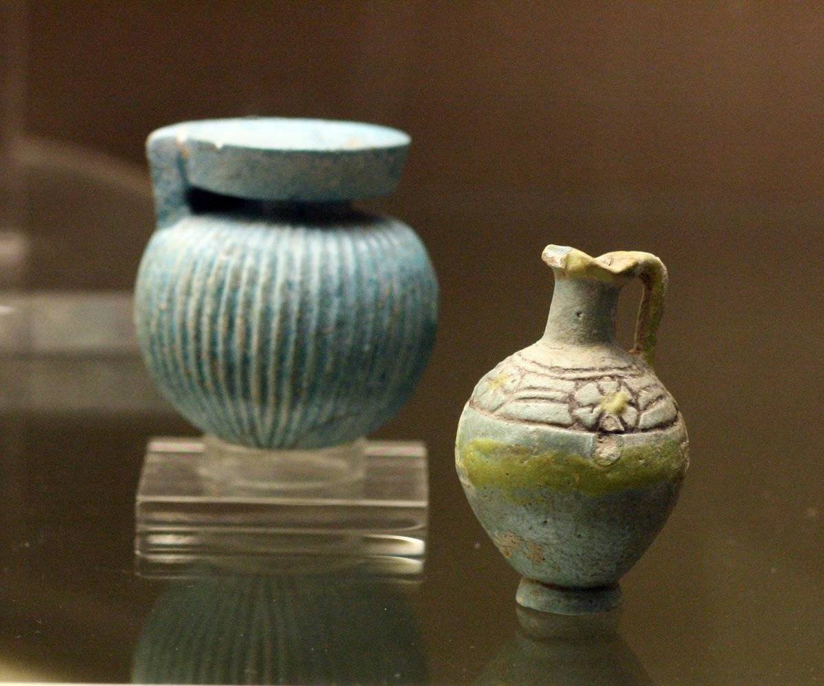 Two ancient Greek perfume bottles are on display at a museum.