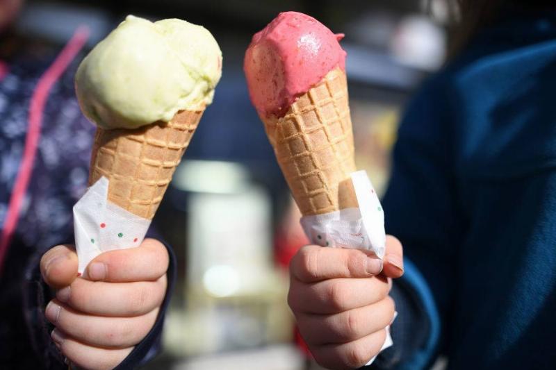 two ice cream cones with yellow and red ice cream