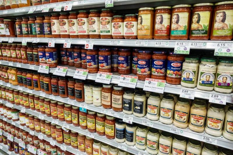 tomato sauce displayed on grocery store shelves