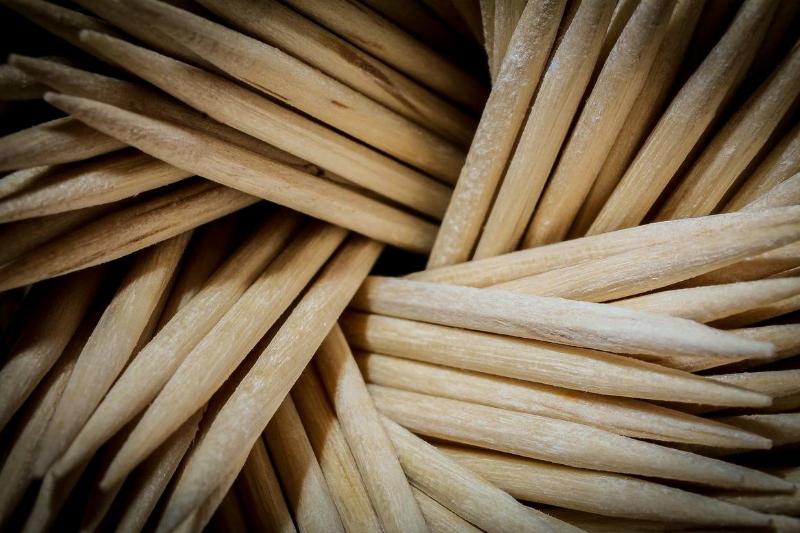 Toothpicks are piled on top of each other.