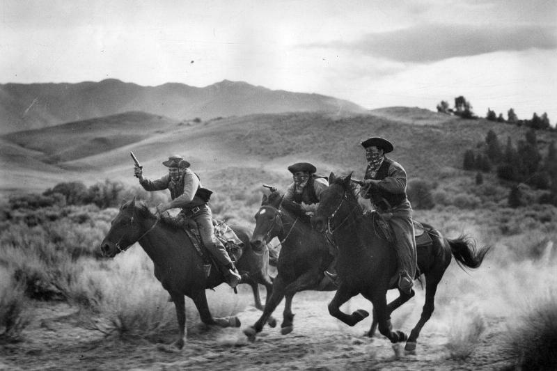 Dawson's henchmen attempt to rob a stagecoach during a scene from the film 'Trail Of The Vigilantes', directed by Allan Dwan