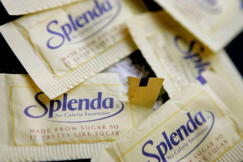Splenda - 51829869  Packets of Splenda lie on a table.