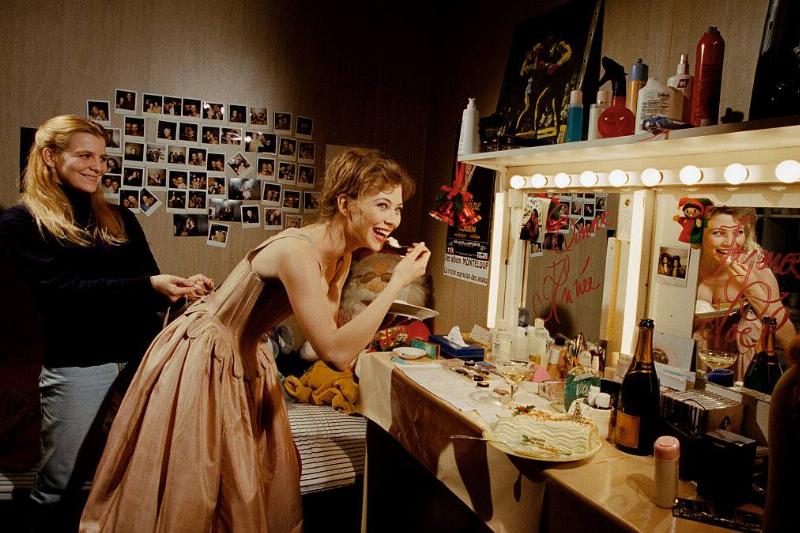 mirror 583501654 woman in a dressing room eating and looking at a mirror