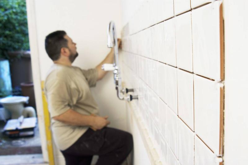 GettyImages-976029196 bathroom tiling man tiling bathroom
