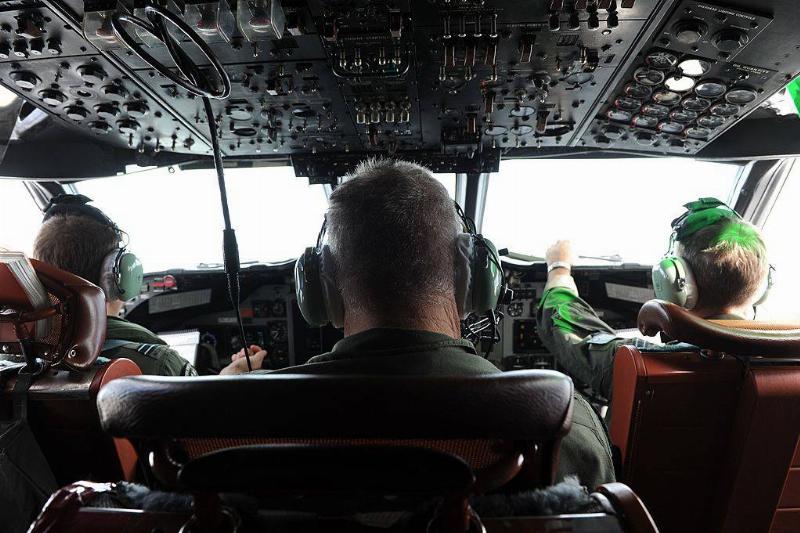 Photo of men in airplane 