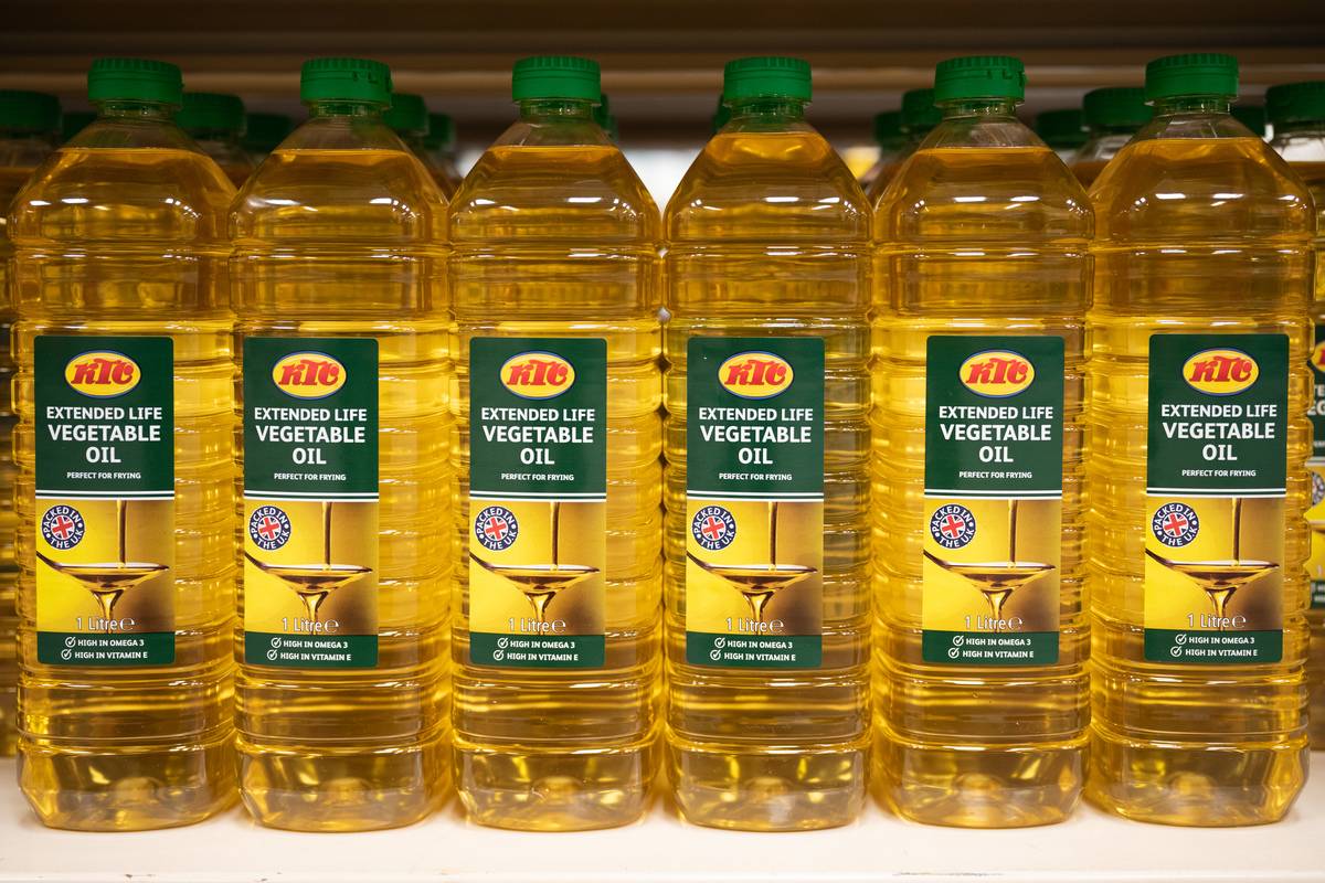 Bottles of vegetable oil stand in a line.