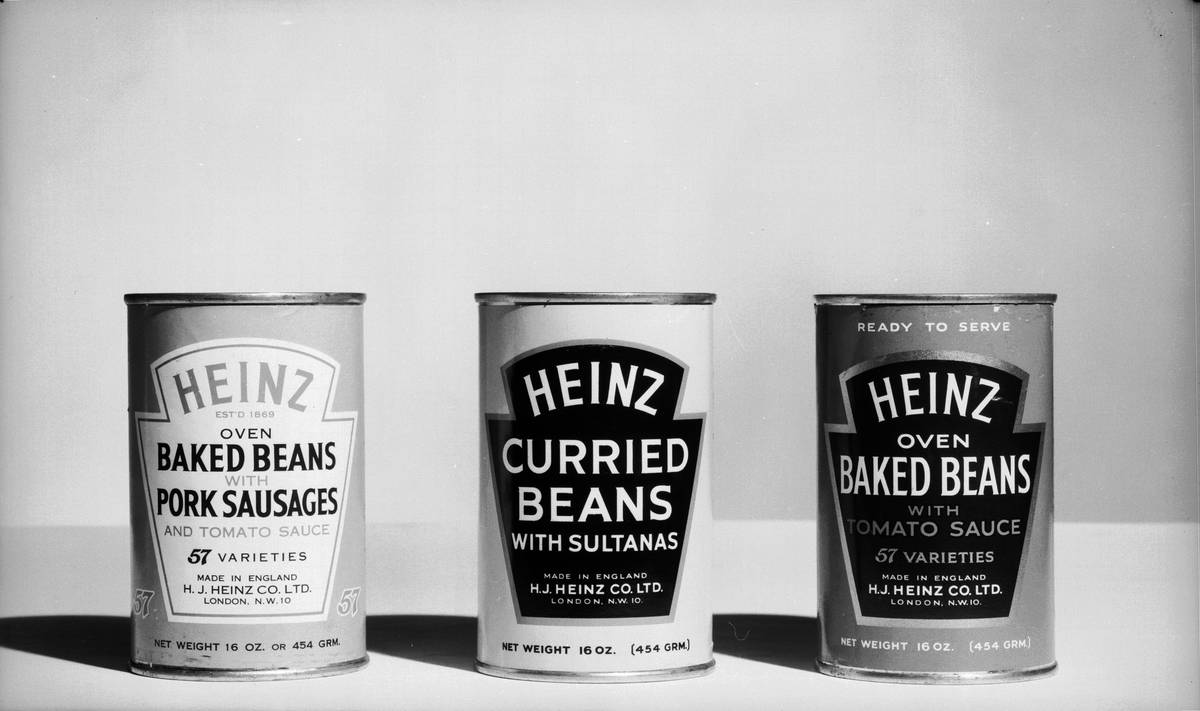 Three cans of beans are on display.