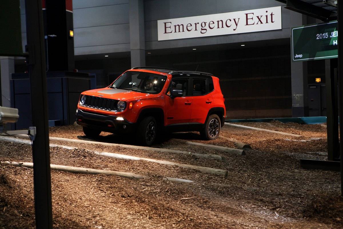 A Jeep Renegade drives outside of an emergency exit.