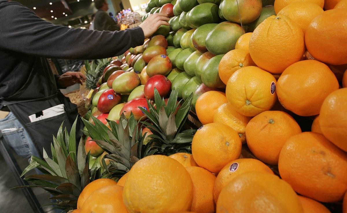 A person selects fruits for sale.