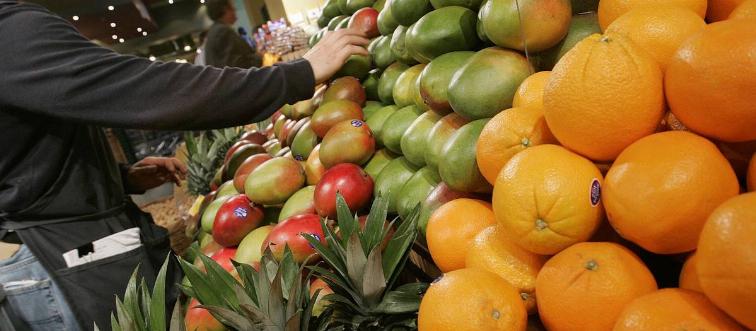 A person selects fruits for sale.