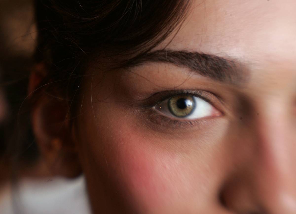 A close-up shows a woman's eye.